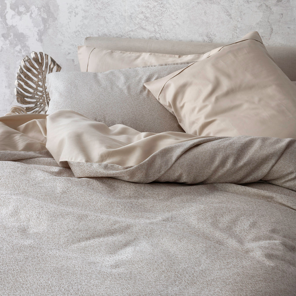 Rio Pearl bedding display with duvet cover and pillowcases. Paired with Capri Sand pillowcases and shams.