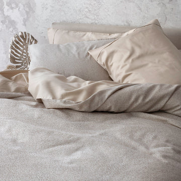 Rio Pearl bedding display with duvet cover and pillowcases. Paired with Capri Sand pillowcases and shams.