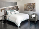 Sinfonia White/ Wilton Blue bedding in bedroom with modern art