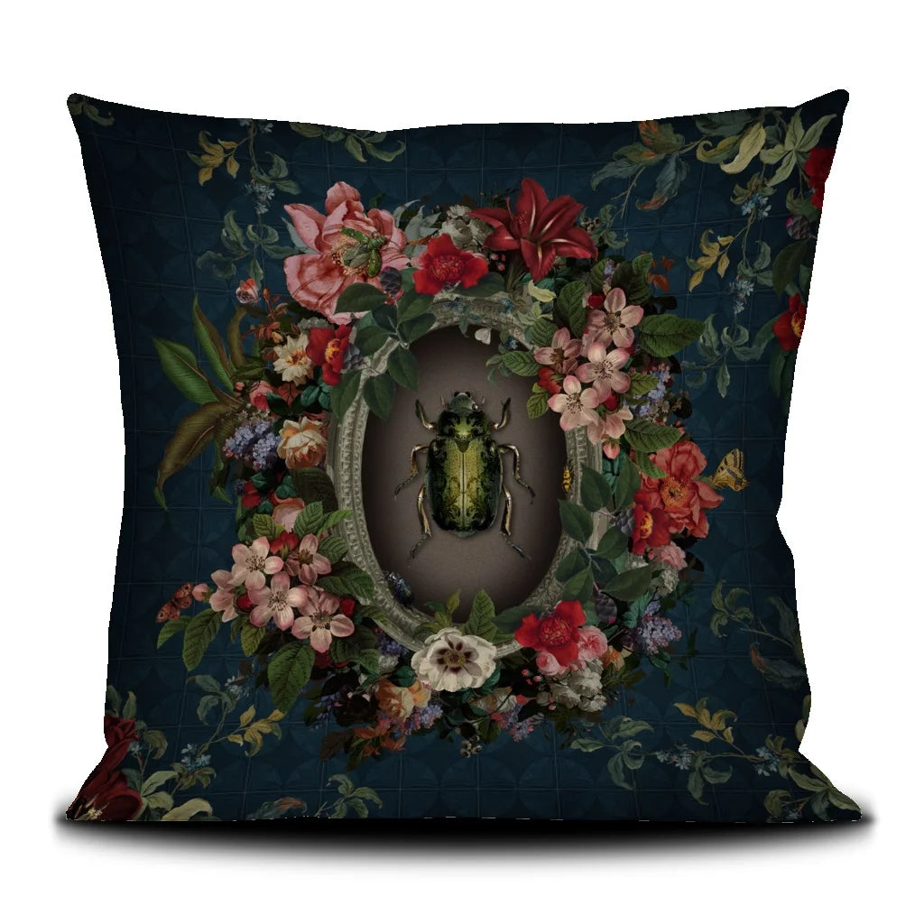 Cushion cover with scarab beetle in a frame surrounded by flowers against blue background