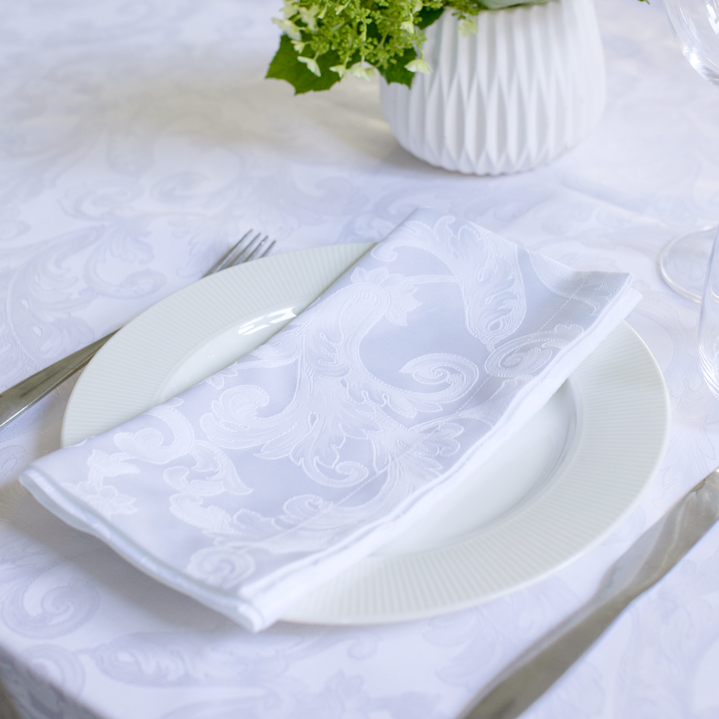 Tivoli White Napkin on plate with Tivoli White Tablecloth under