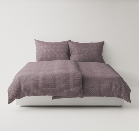Purple textured bedding set up on a bed