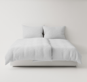 White textured bedding set up on a bed