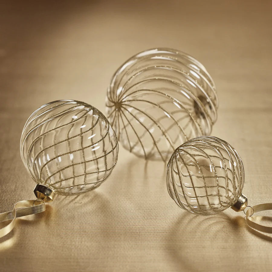 Swirl Glitter Ball Ornaments - Clear and Gold laying down 