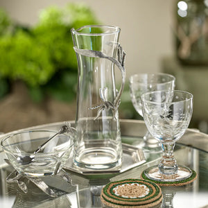 Dragonfly pitcher with pewter dragonfly ornament and leaf handle shown on table with two glasses on right and bowl on left