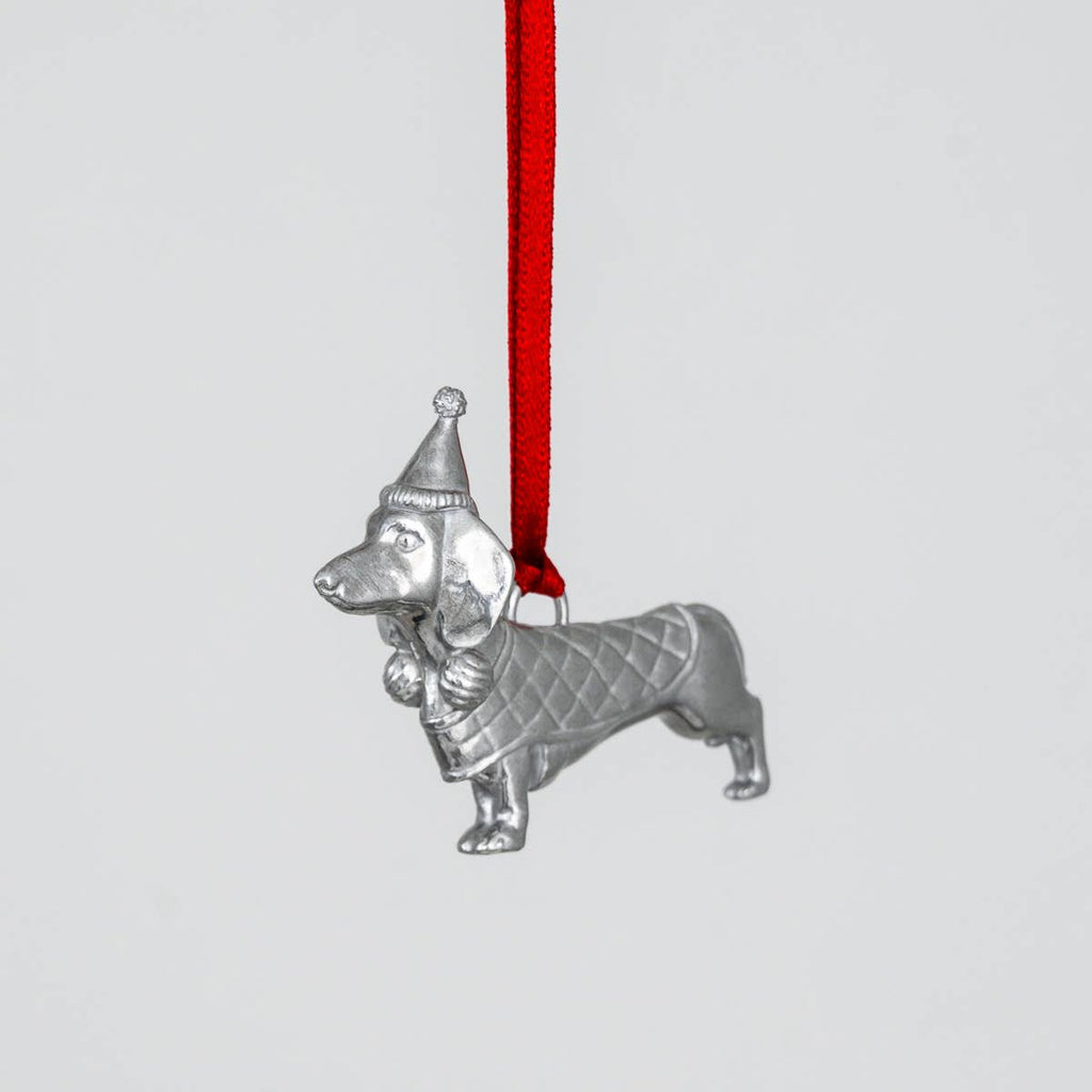 Pewter dachshund ornament with a red ribbon on a light gray background