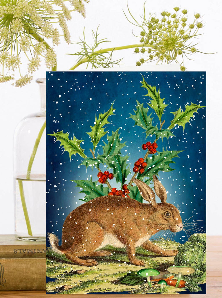 Card with a hare and holly design on a snowy night background