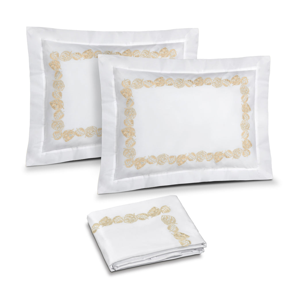 Feuillage Embroidery in White / Ivory shown on two shams and duvet cover