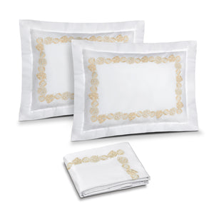 Feuillage Embroidery in Ivory shown on two shams and duvet cover