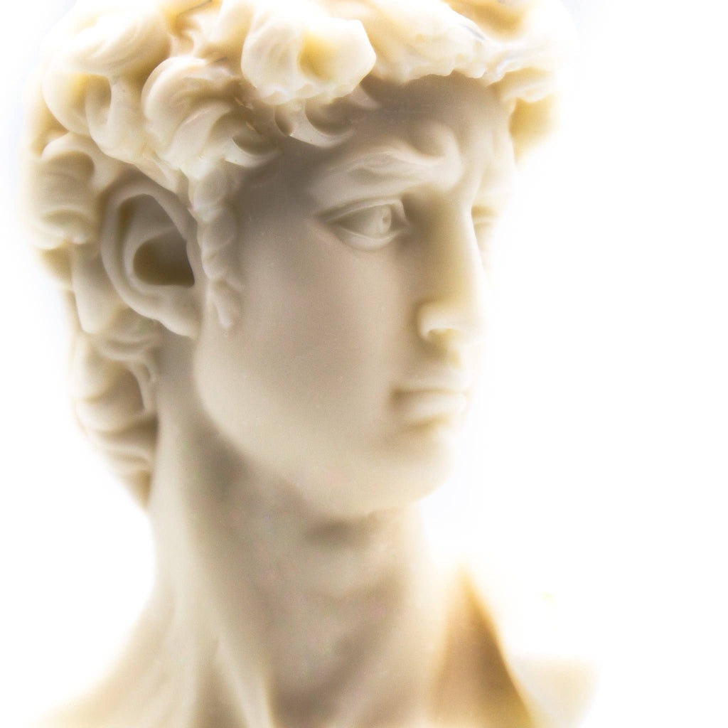 Candle bust of a classical figure on a white background