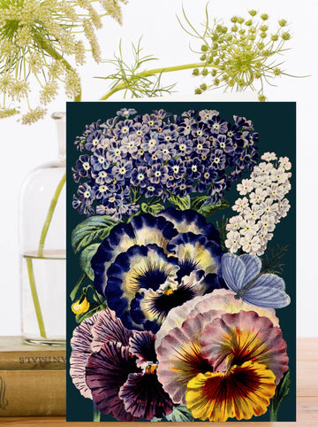 Greeting card with floral arrangement of pansies, hydrangeas, and other flowers on a dark background.