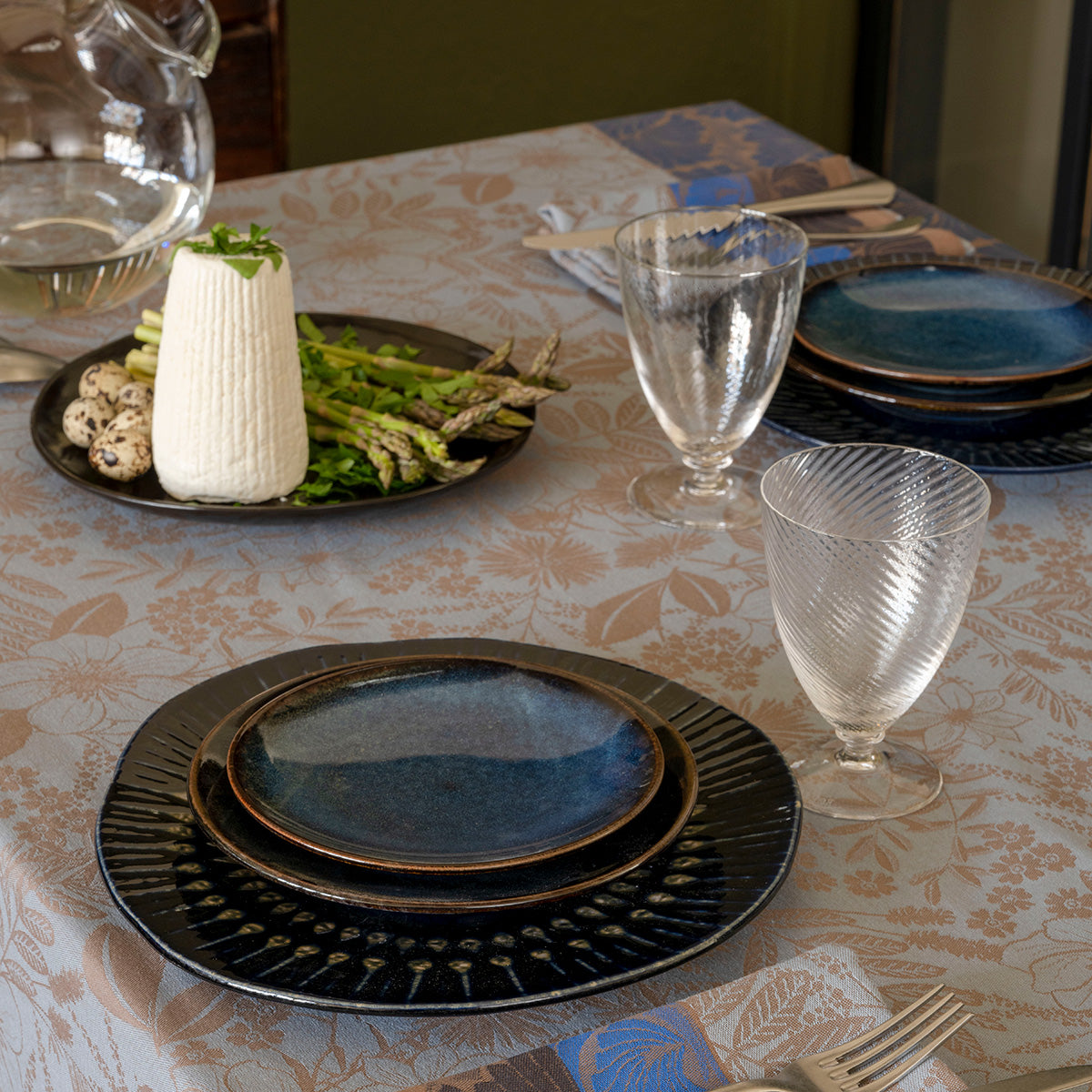 Medium close up of Cottage Blue tablecloth with table setting on it