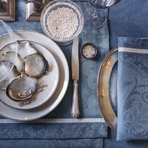 Close up of Armoiries Blue tablelinens shown with tablesetting and oysters and pearls