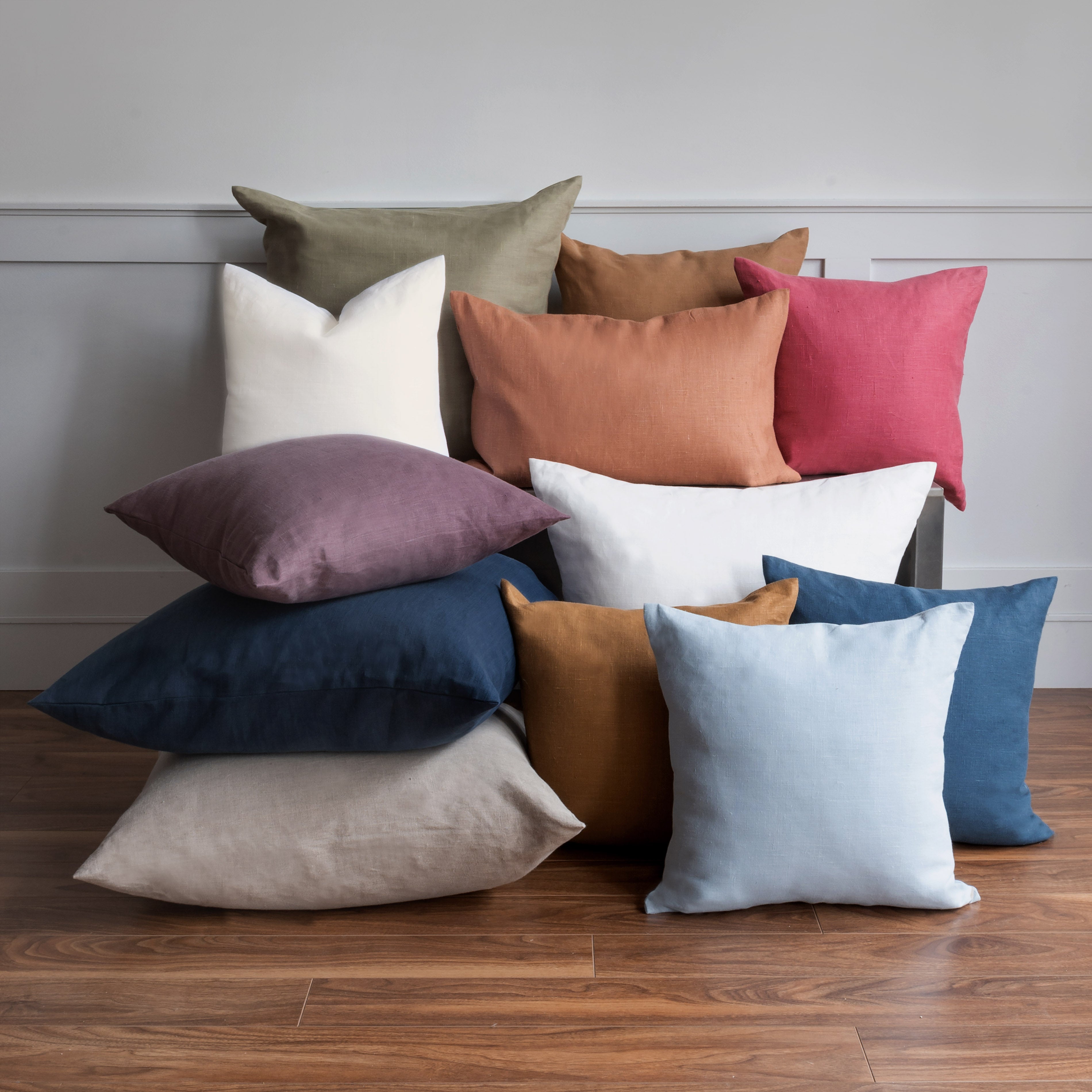 A stack of Linho cushions in various sizes and colours