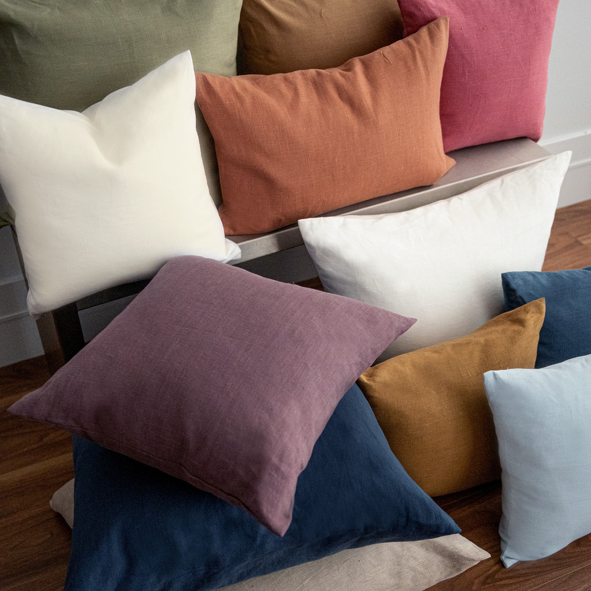 A stack of Linho cushions in various sizes and colours