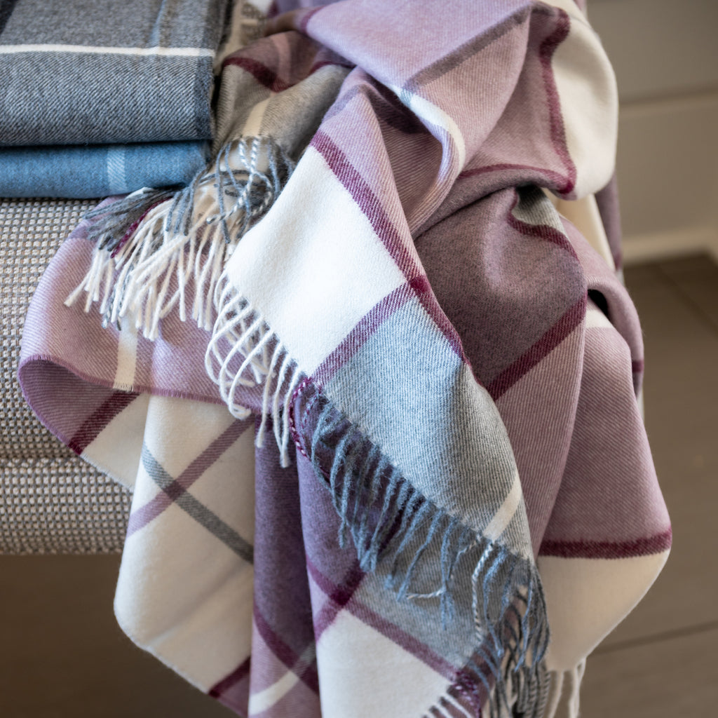 Mika Amethyst throw draped with other Mika throws in background on chair