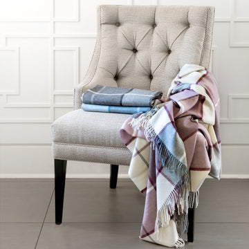 Mika throws in 3 colours stacked and draped on chair