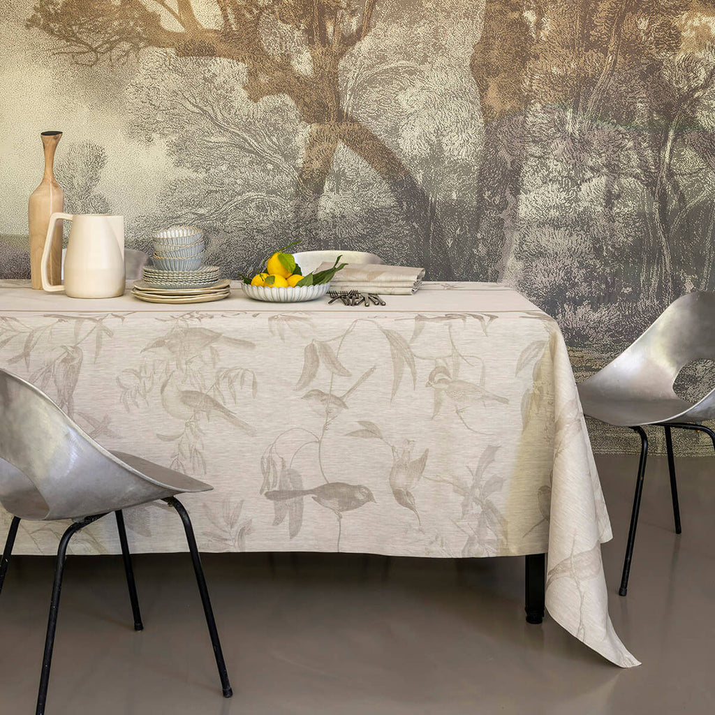 Voliere Beige Tablecloth on a rectangle Table with table setting and a bowl of lemons 